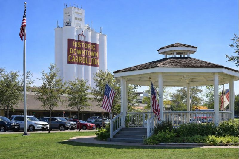 Historic Downtown Carrollton grain silos and gazebo under a clear blue sky in Carrollton, Dallas County, Texas