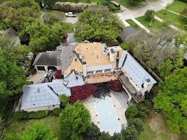 Aerial view of a large home with pool in Plano, TX before new roof installation, showing roof stripped and prepped for replacement