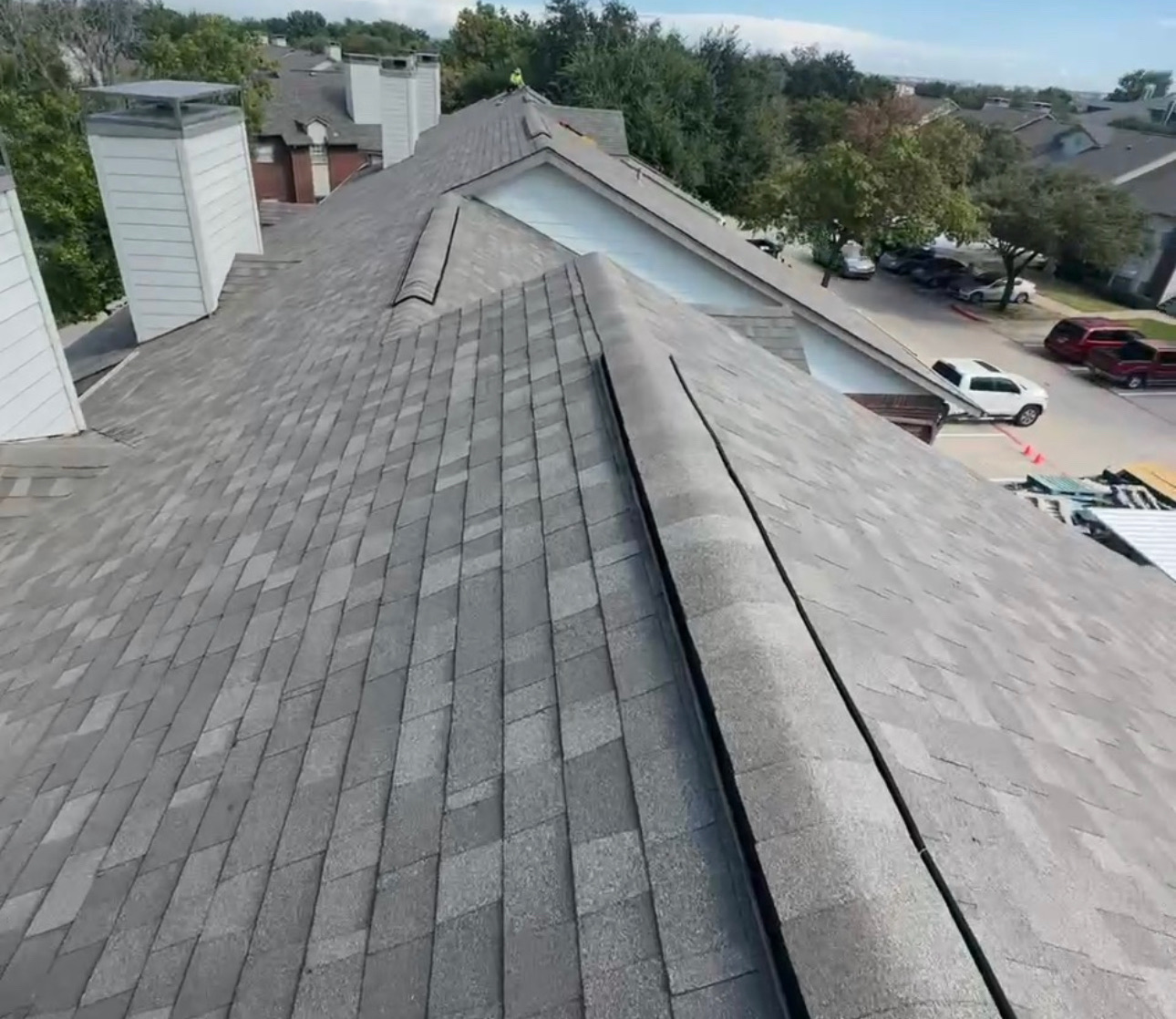 Completed shingle roof installation on multi-unit apartment building in Irving, TX