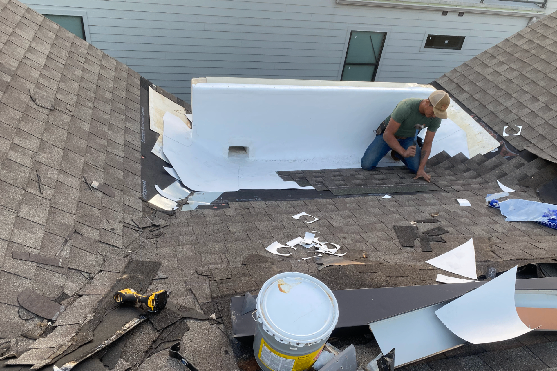 Townhouse roof before repair showing damage - Medical District Dallas TX roofing services